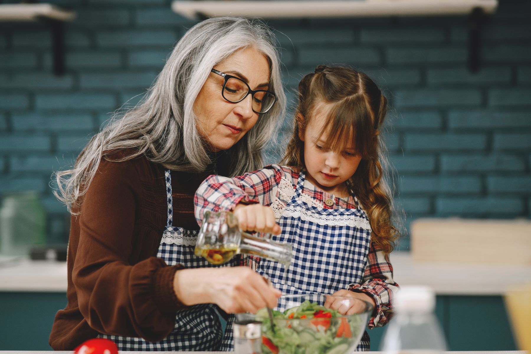 A grandmother and child preparing food together