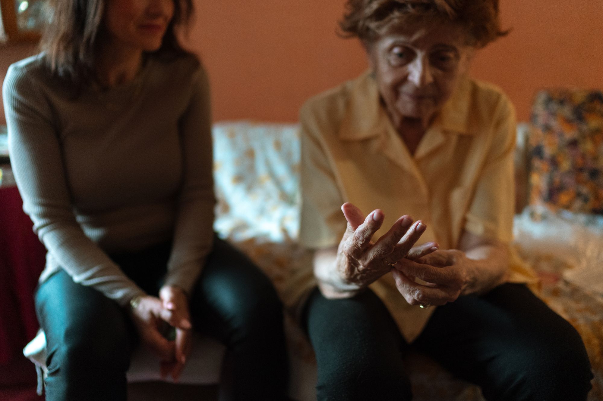 Two women sitting together during a quiet conversation at home